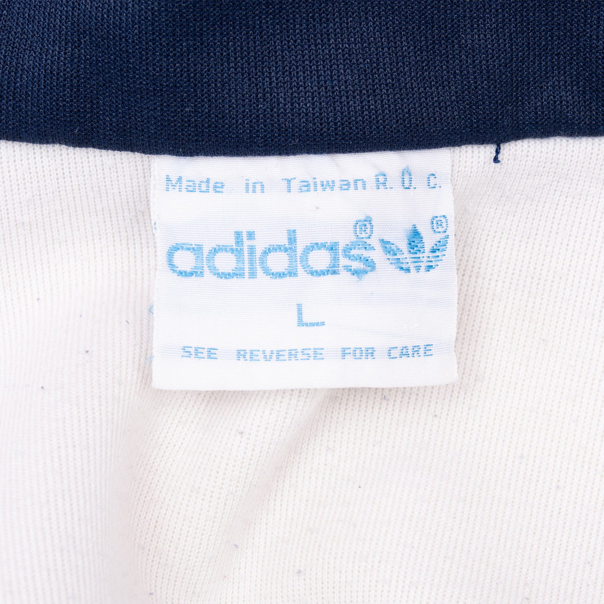 Adidas neck label with Trefoil logo, size L, care note and Made in Taiwan R.O.C. text