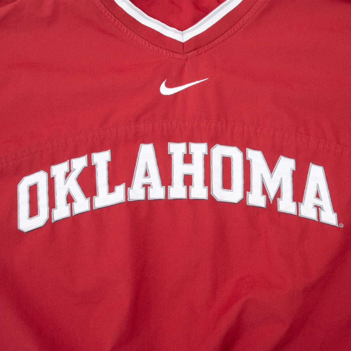 White Oklahoma chest lettering outlined in gray with embroidered Nike Swoosh