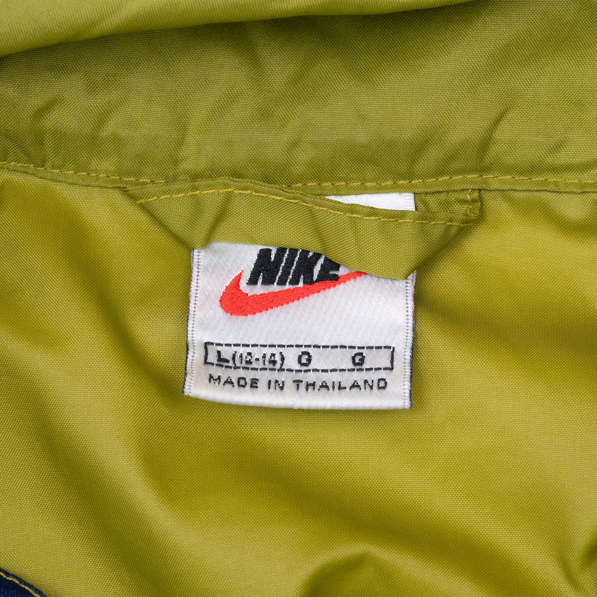 Nike neck label marked women's size large and made in Thailand