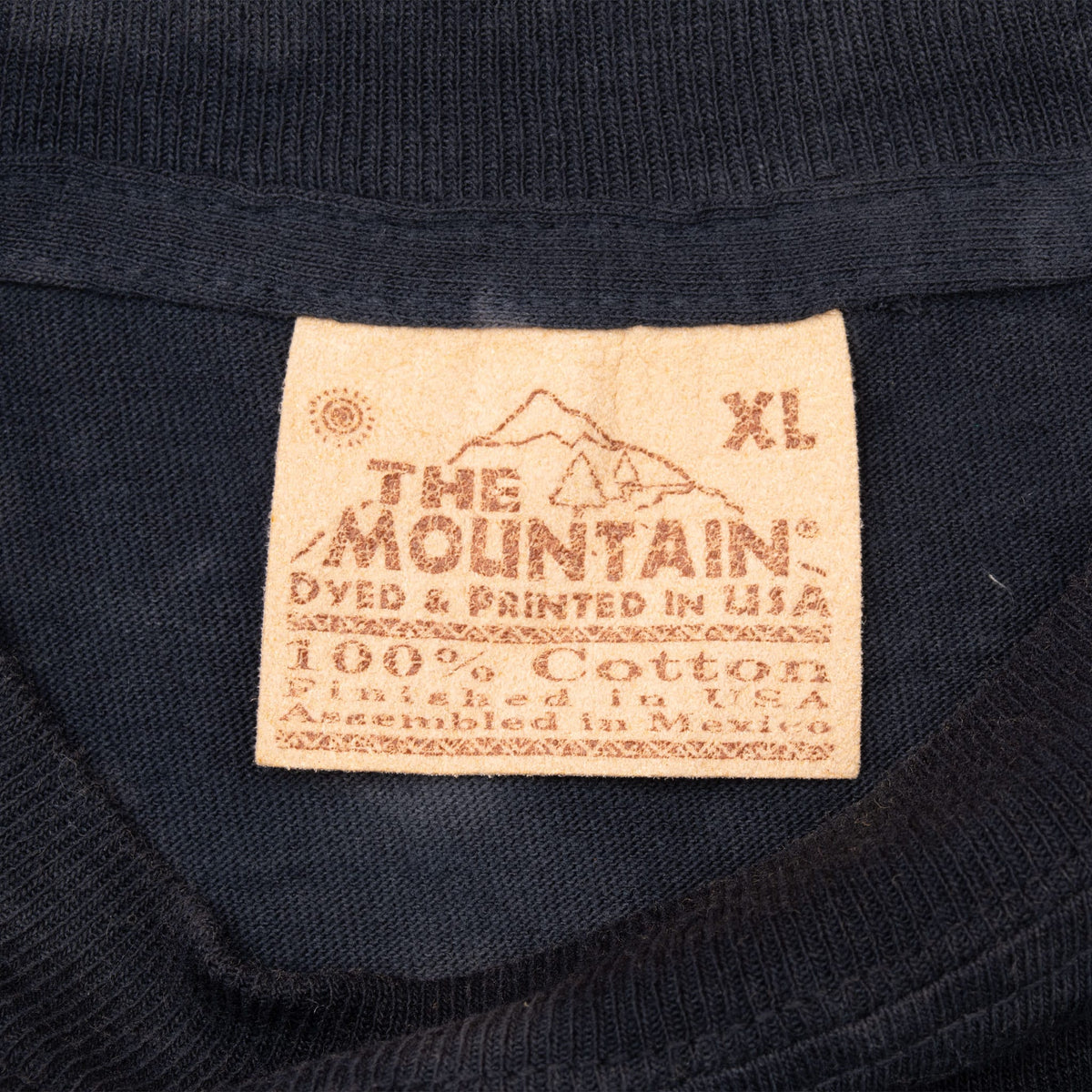 The Mountain neck tag marked XL and 100% cotton
