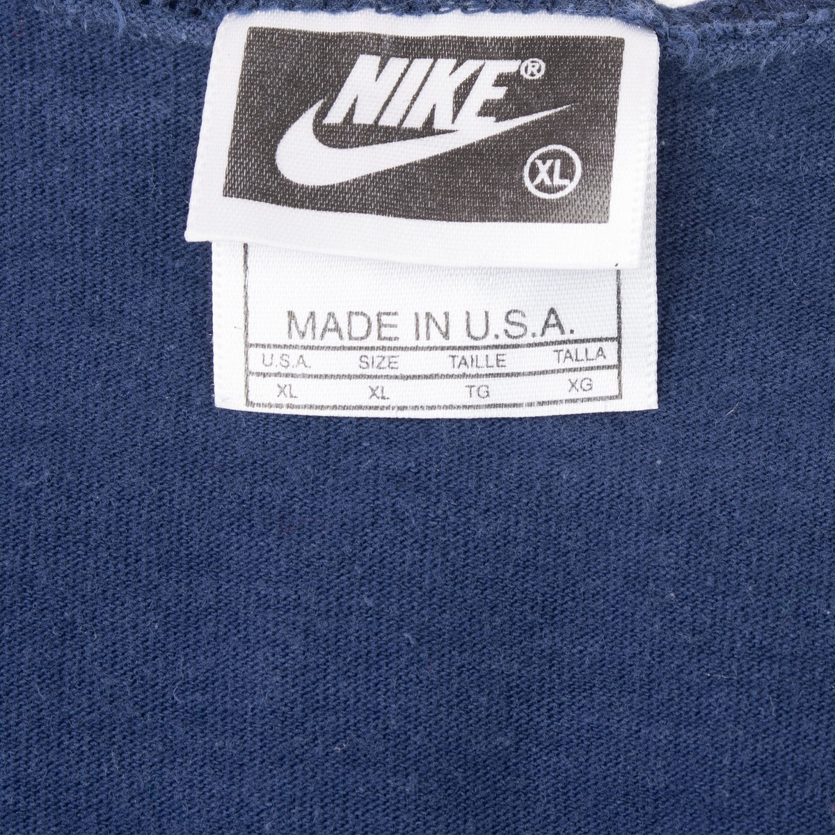 Nike neck tag marked XL and Made in U.S.A. inside navy blue tank top