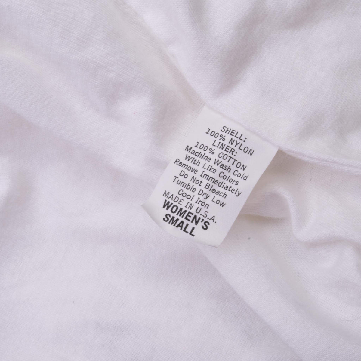 Care label inside Nike jacket showing women's small and fabric details