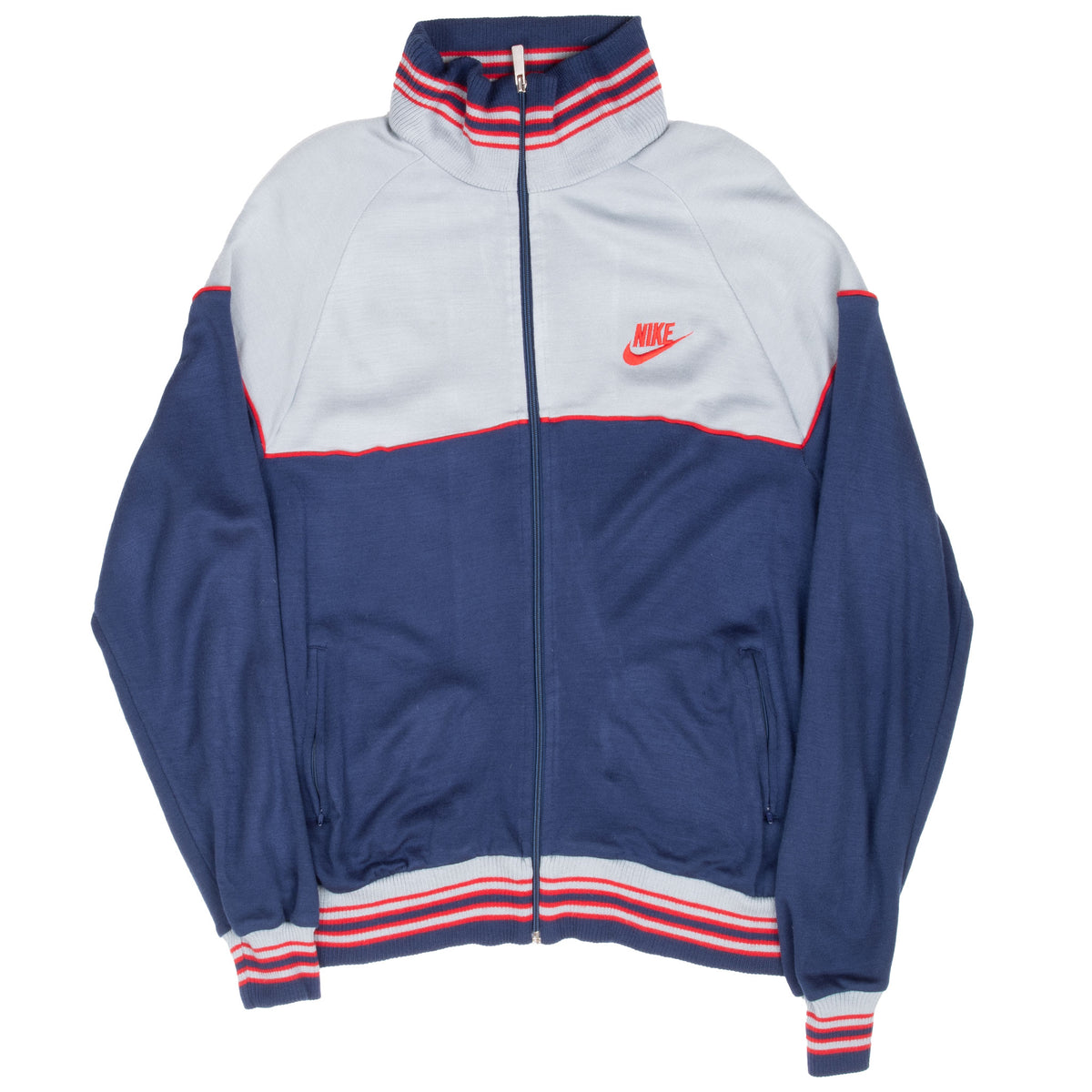 Full front view of grey and navy Nike track jacket with red piping and striped cuffs