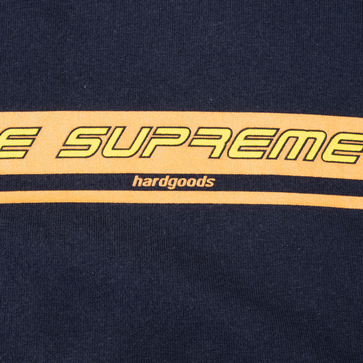 Close-up of orange Supreme stripe graphic with small hardgoods detail