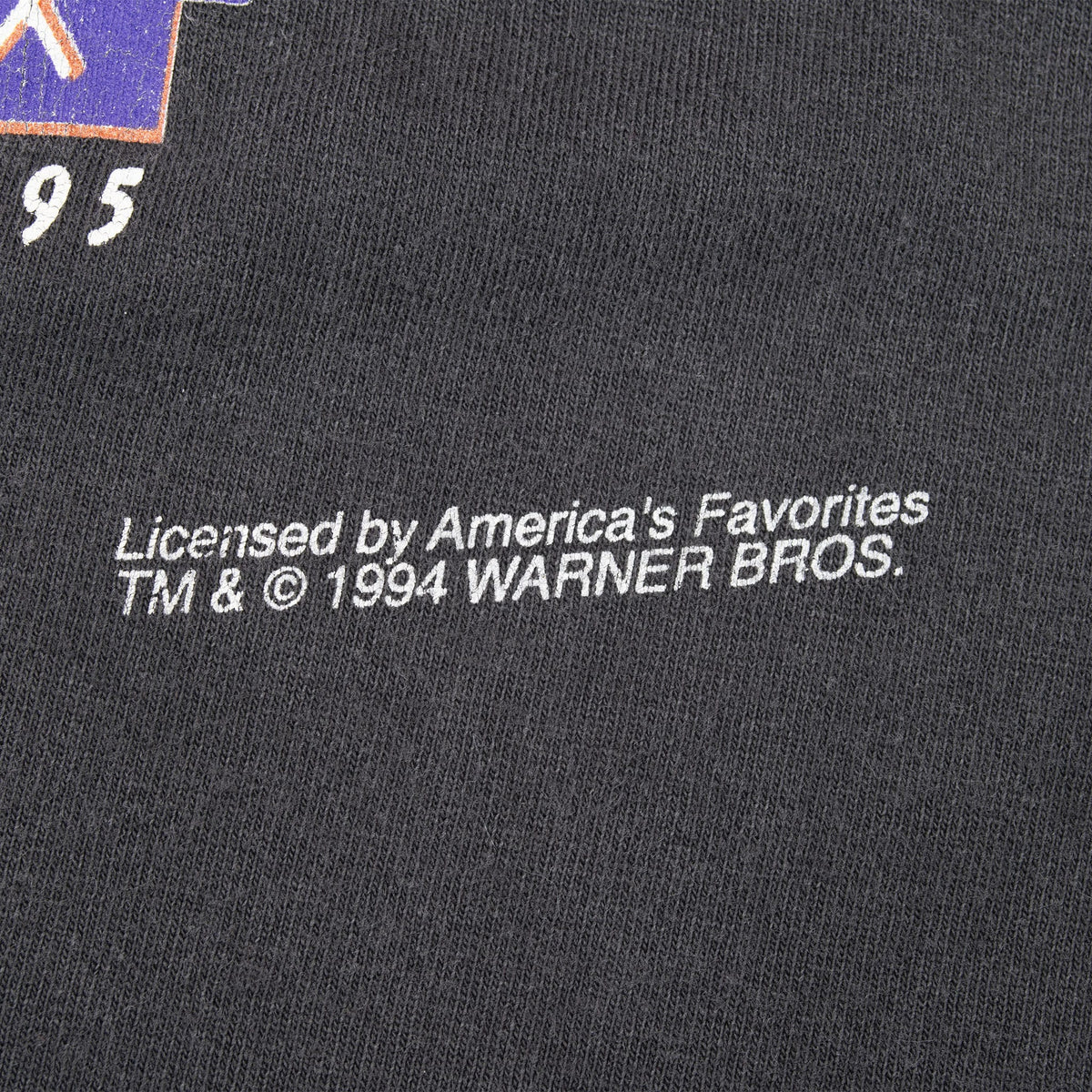 Close-up of Warner Bros. licensing text printed beneath the front graphic