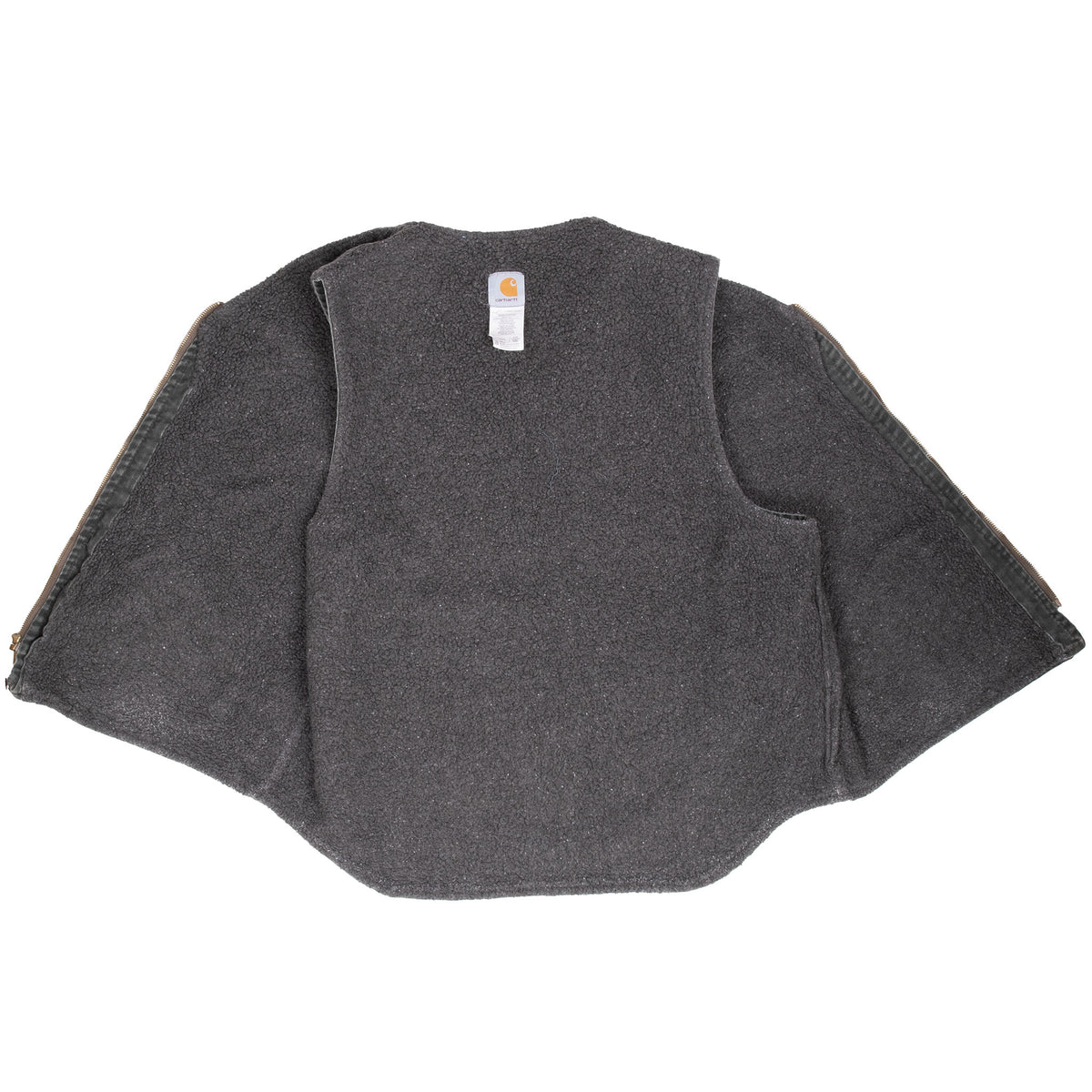 Open Carhartt vest showing the dark sherpa-lined interior and neck label