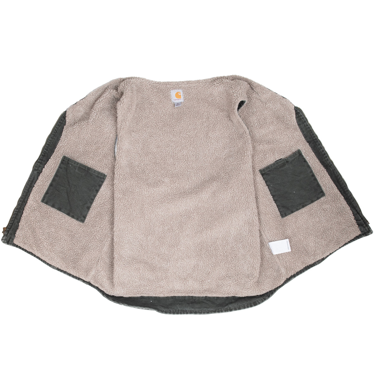 Open Carhartt vest showing beige sherpa lining and two interior pockets