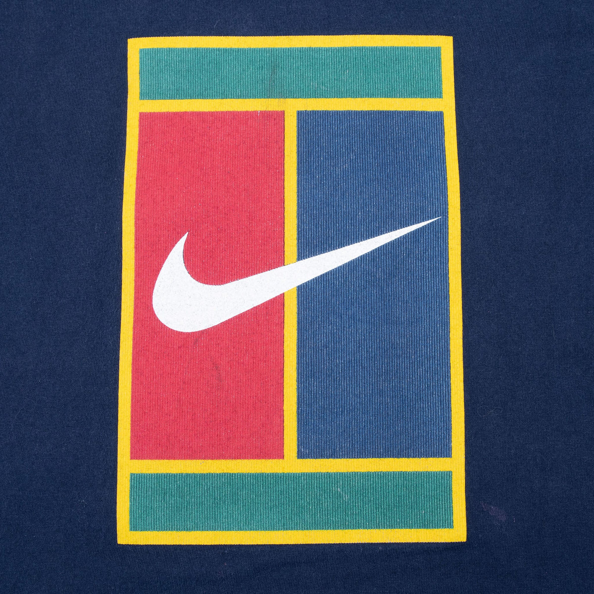 Close-up of yellow, green, red and blue tennis-court print with white Nike Swoosh