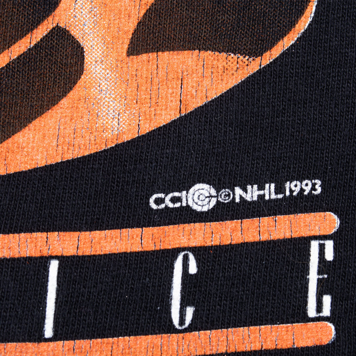 Close-up of NHL 1993 copyright mark on orange and black front print