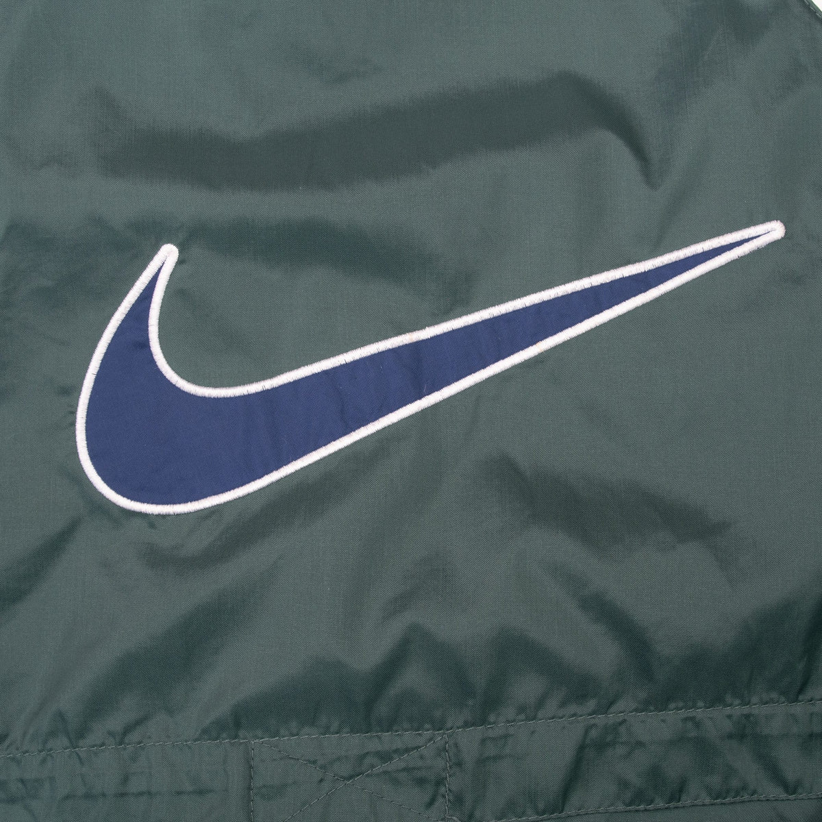 Close-up of oversized navy and white Nike Swoosh graphic on back