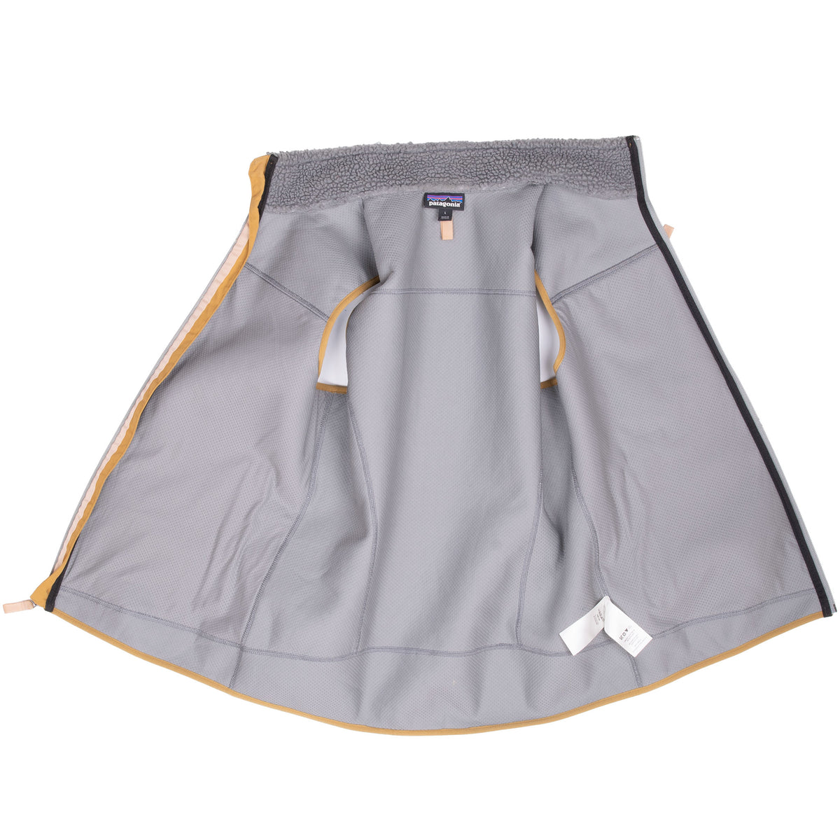 Open interior of Patagonia grey fleece vest showing lining, seams, and tags