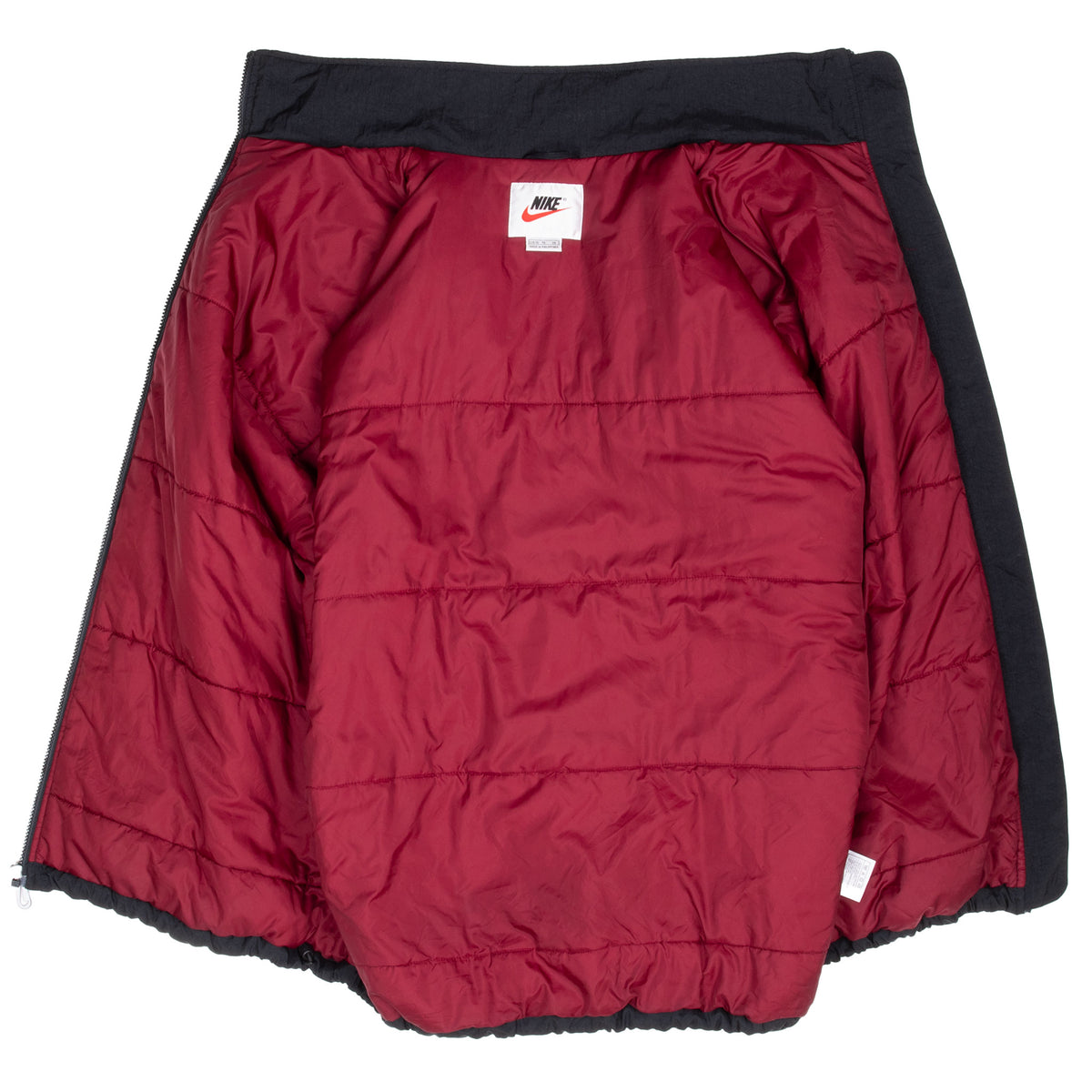 Interior of Nike windbreaker jacket showing burgundy quilted lining and neck label