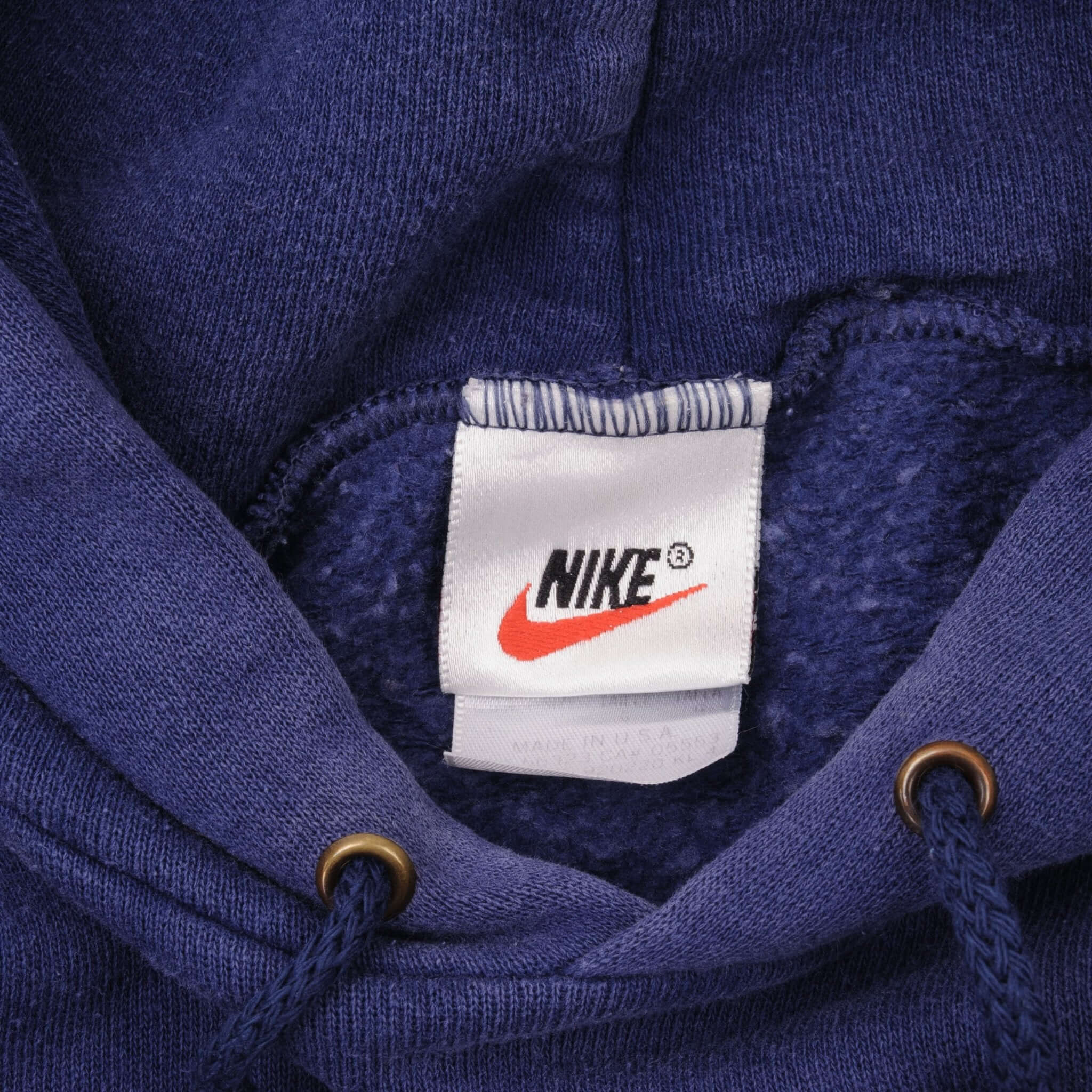 Close-up of Nike neck tag inside blue hoodie