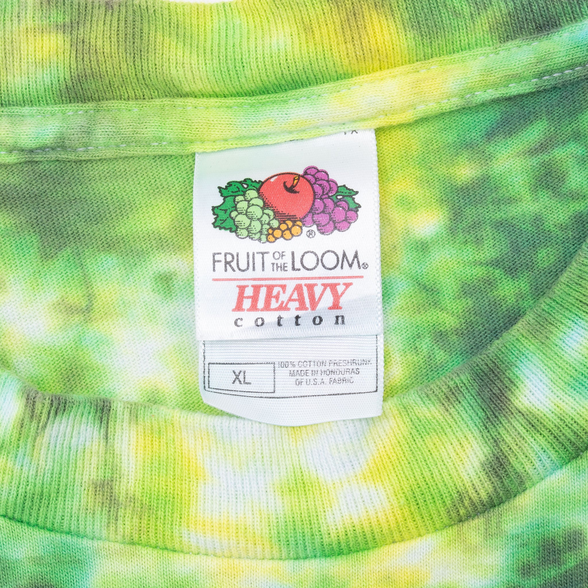 Close-up of a 'Fruit of the Loom' label on tie-dye fabric. Vintage Tie Dye Tee Shirt Size Large 2000S