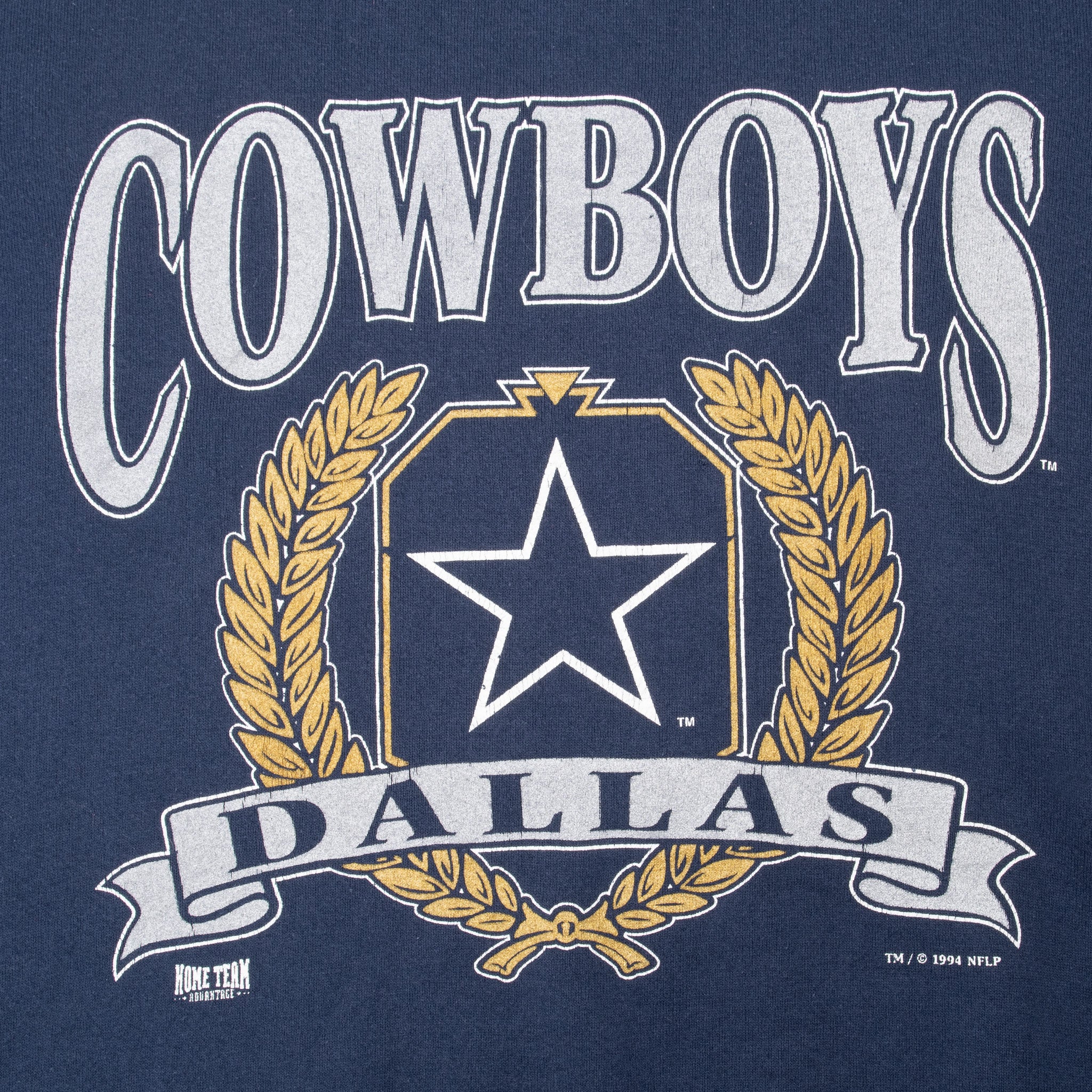 Close-up of Dallas Cowboys star, gold wreath, and banner chest graphic