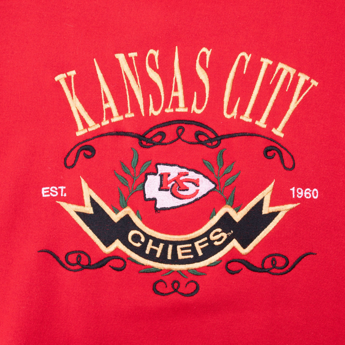 Close-up of Kansas City Chiefs crest embroidered on red sweatshirt