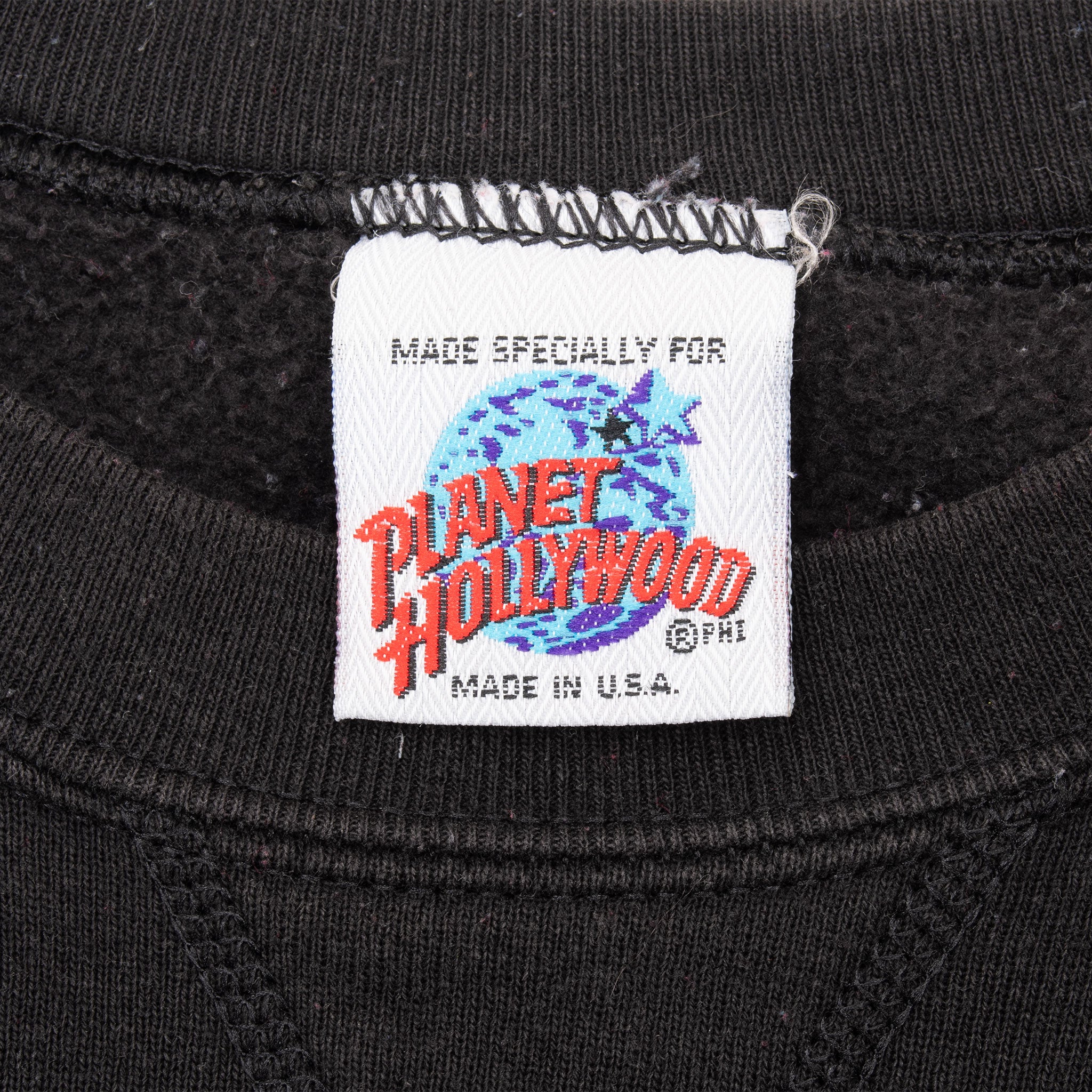 Planet Hollywood neck label with globe logo and Made in U.S.A. text