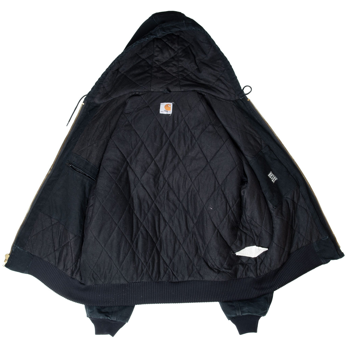 Open Carhartt J140 jacket showing black quilted lining and interior pockets