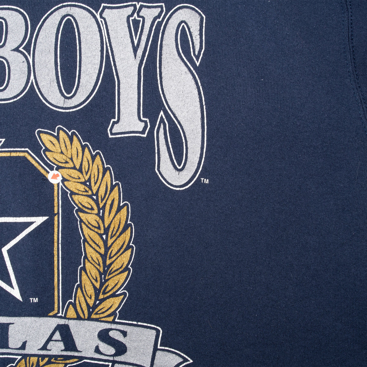Close-up of the right side of the Cowboys lettering and gold wreath print