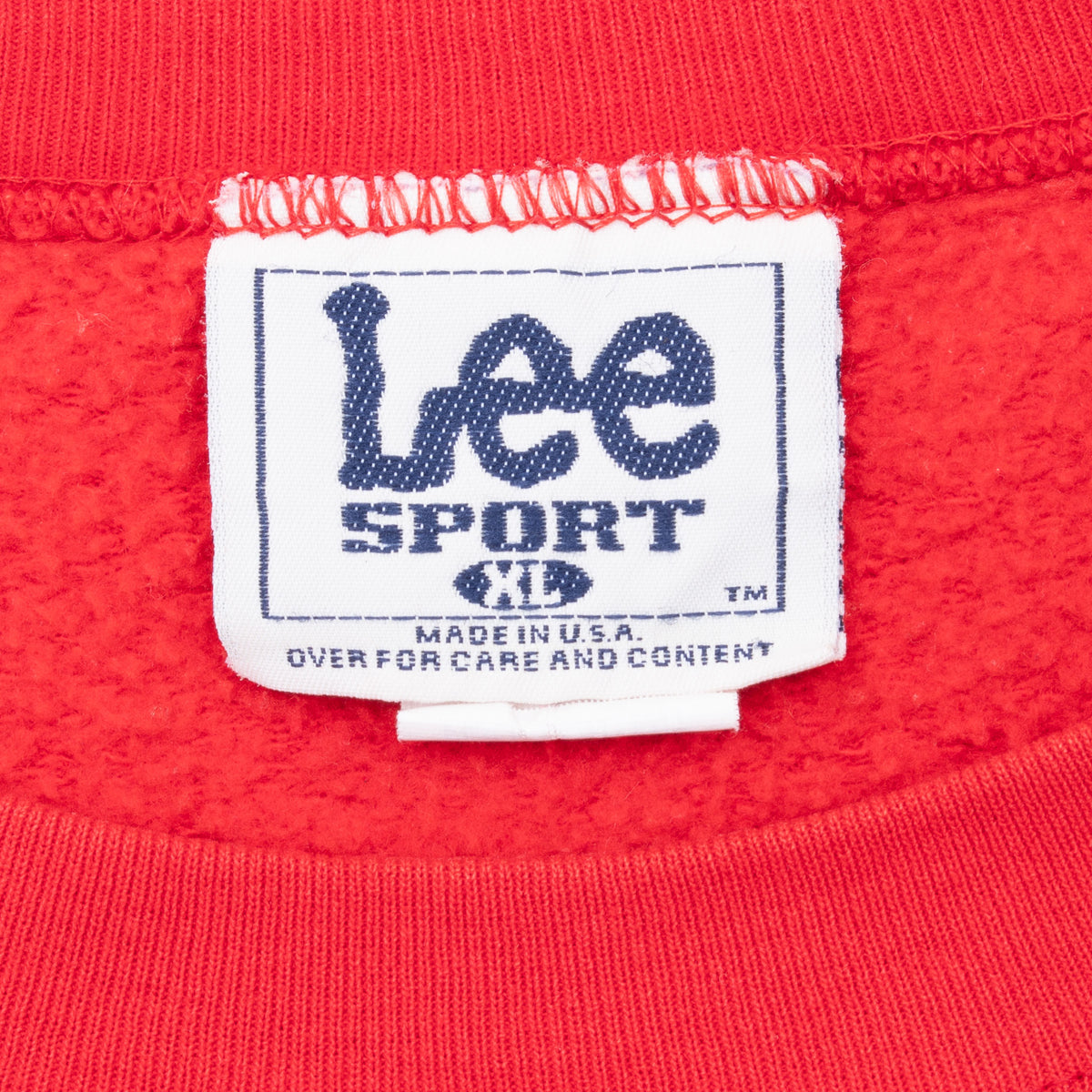 Lee Sport XL neck label inside red sweatshirt showing Made in USA text