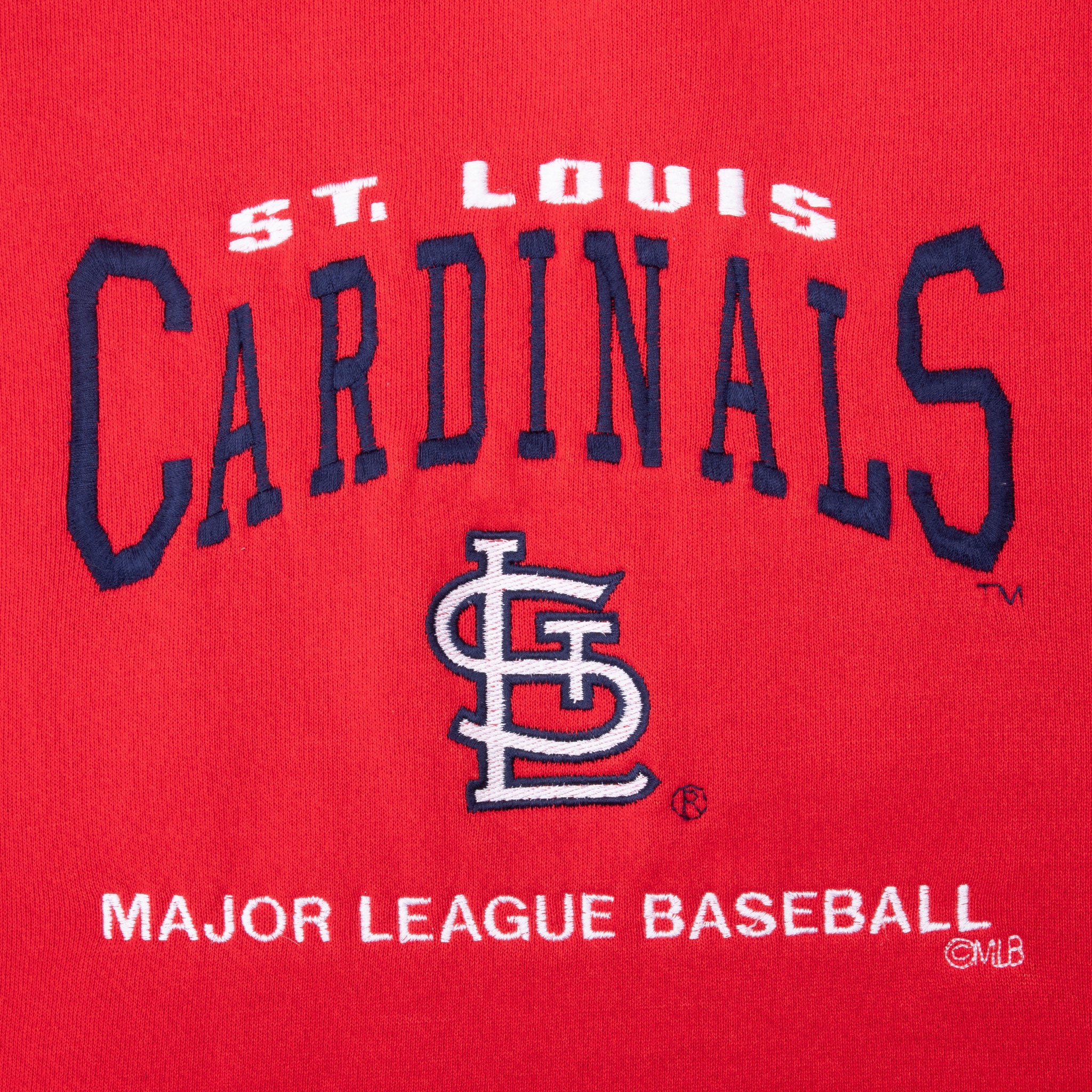 Close-up of St. Louis Cardinals and STL logo embroidery on red sweatshirt