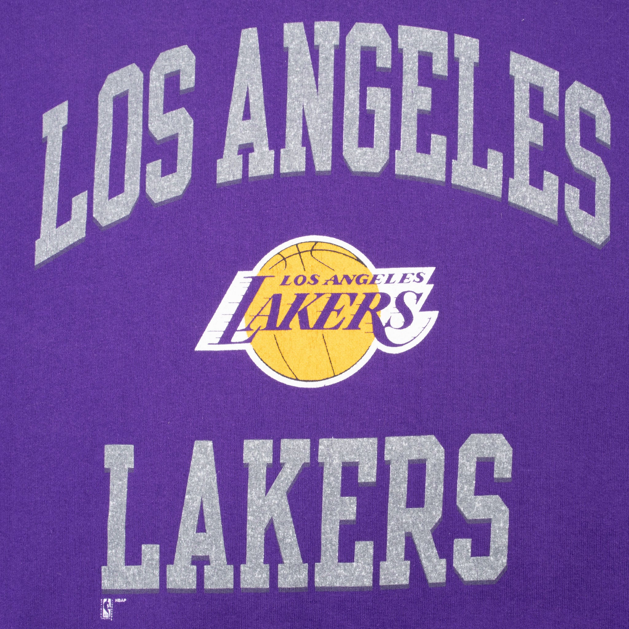 Close-up of gray Los Angeles Lakers lettering and yellow basketball team logo