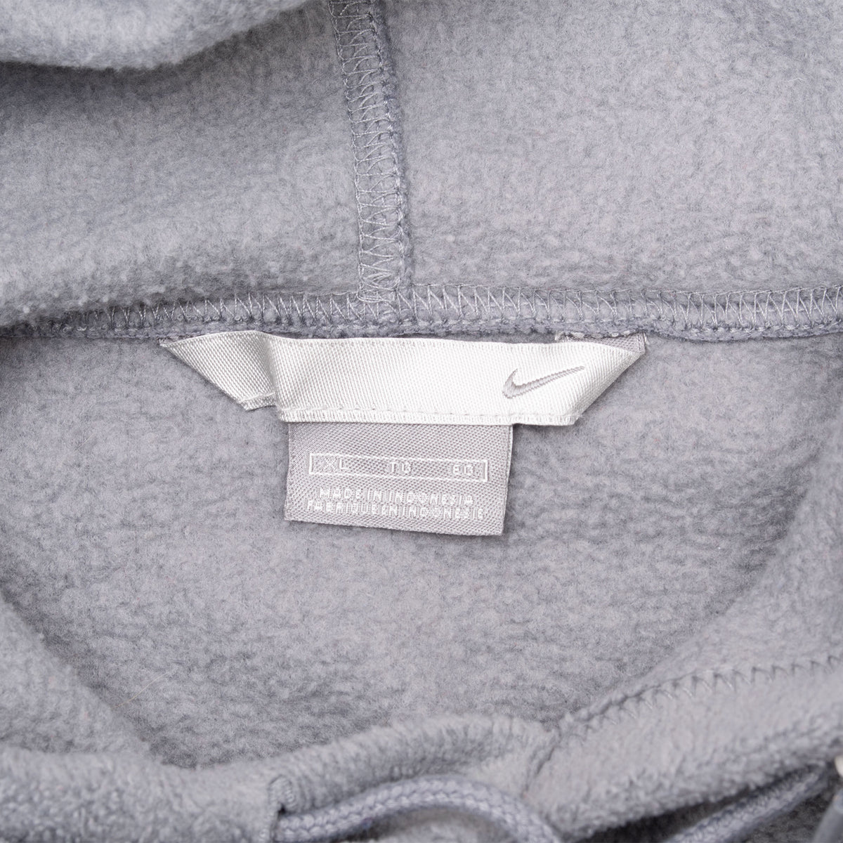 Close-up of Nike neck tag inside grey fleece hoodie