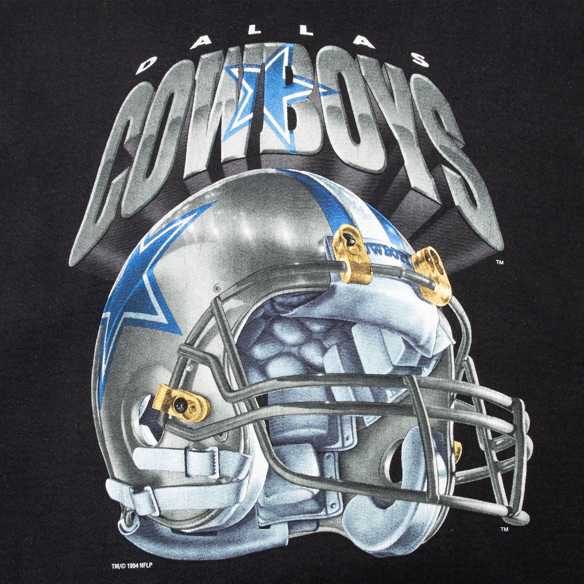 Close-up of Dallas Cowboys text, star, and silver football helmet graphic