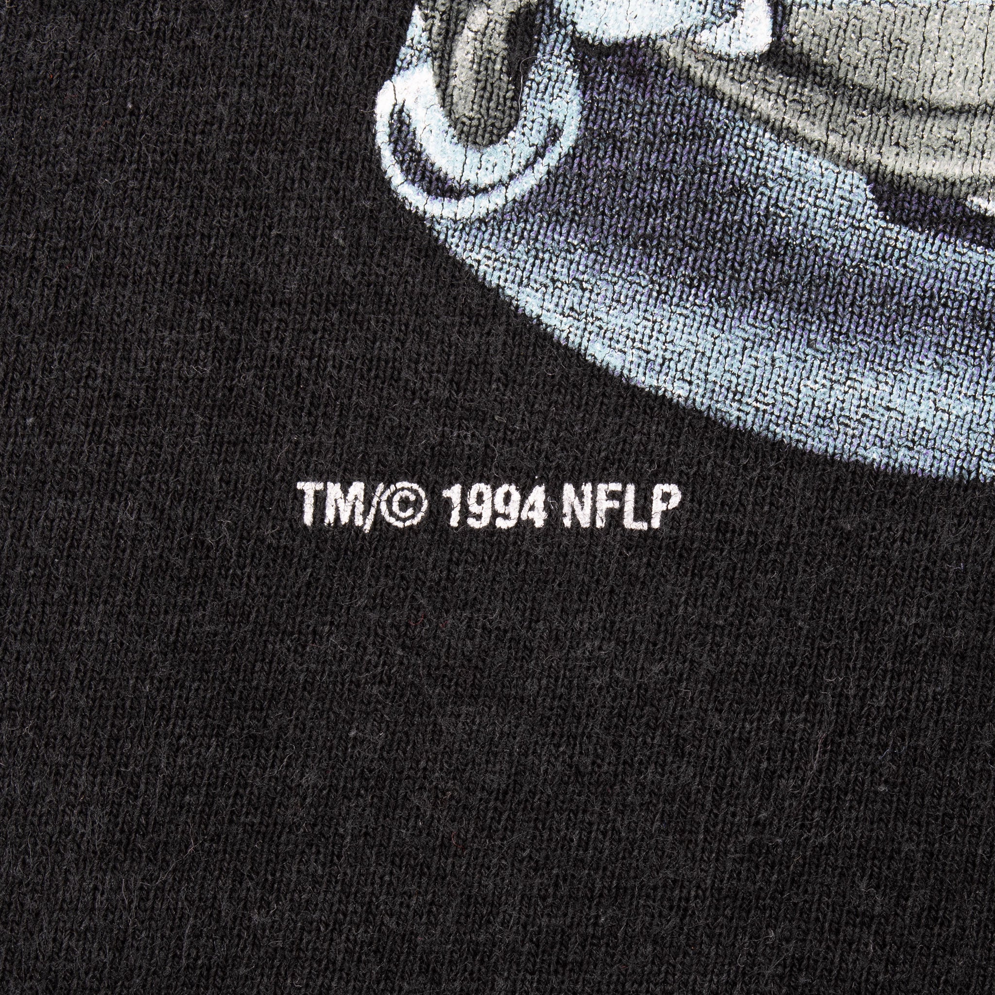 Close-up of TM/© 1994 NFLP copyright text beneath the front graphic