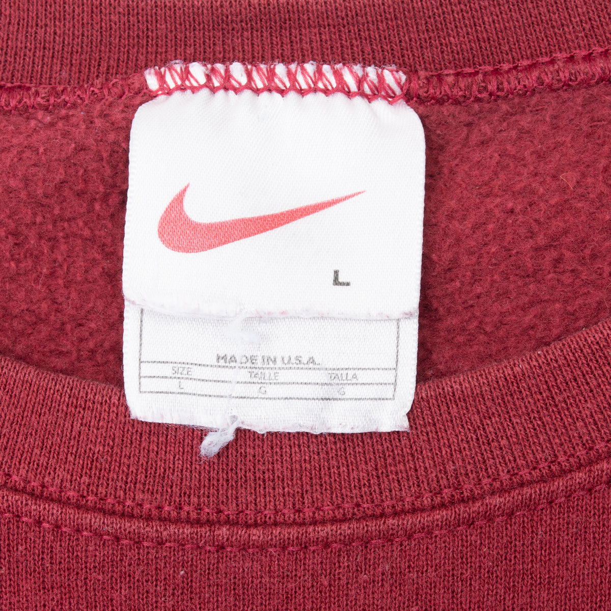 Nike neck tag showing swoosh, size L, and Made in USA text