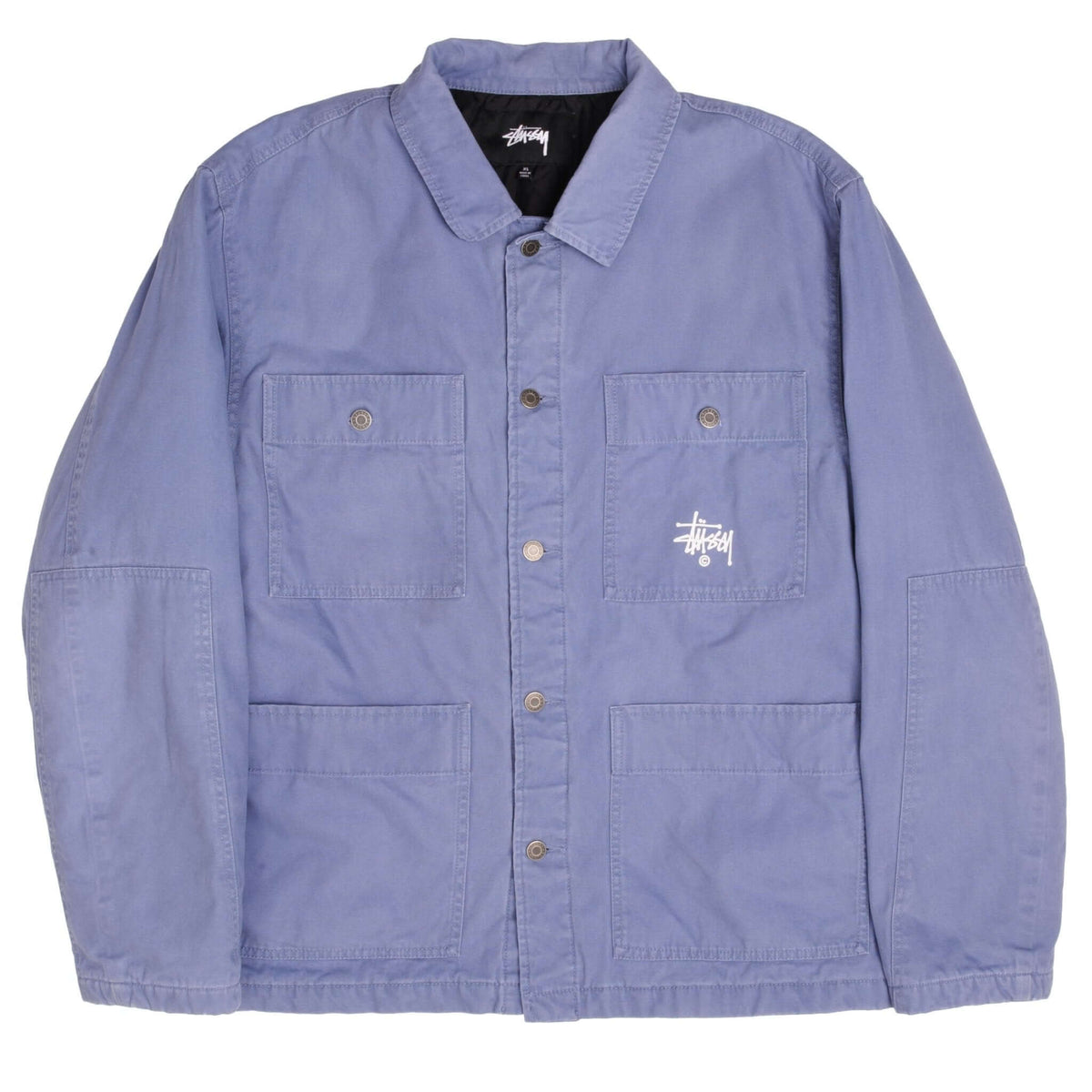 Front of blue Stussy chore jacket with snap buttons, four pockets, and white chest logo