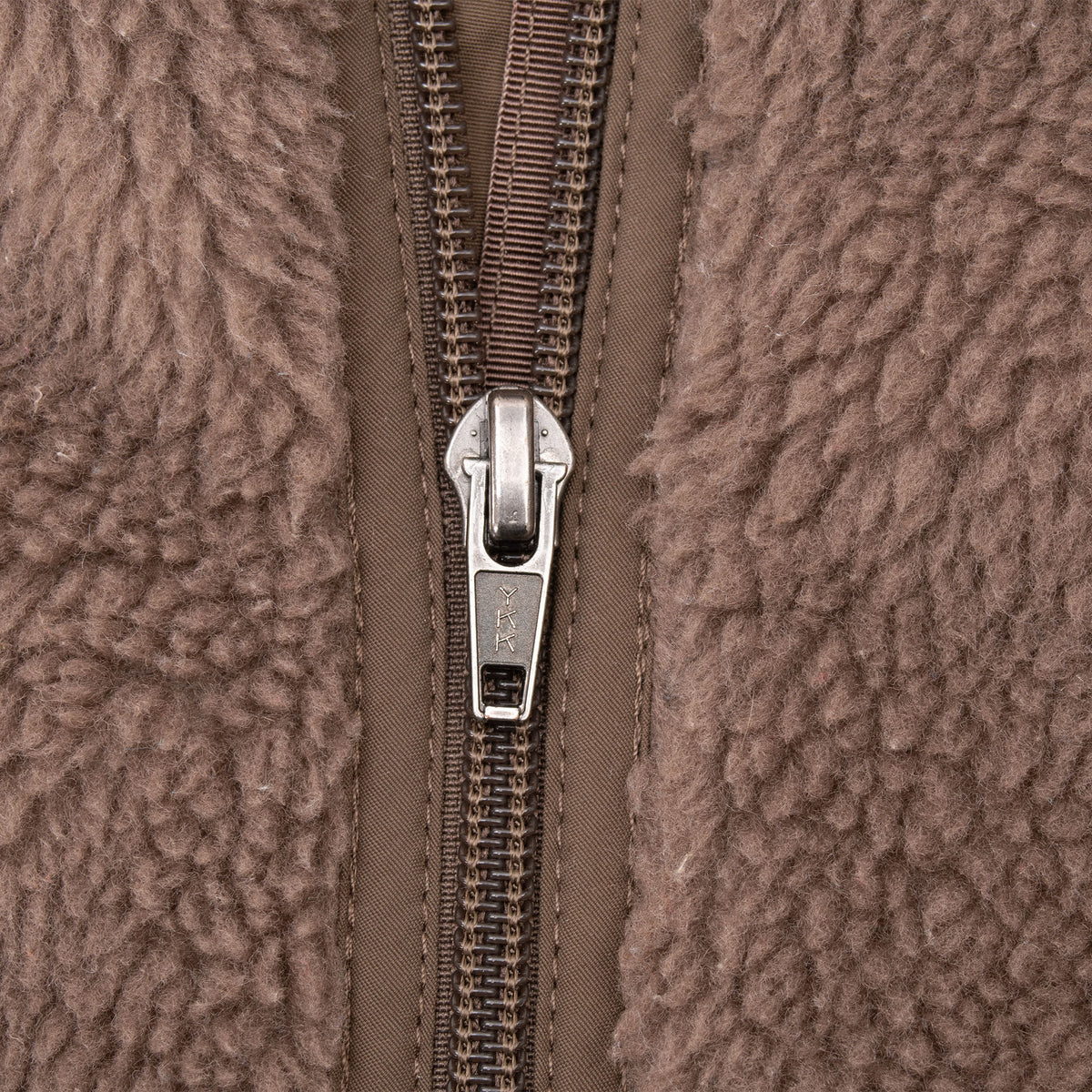 Close-up of front zipper on brown Patagonia fleece vest