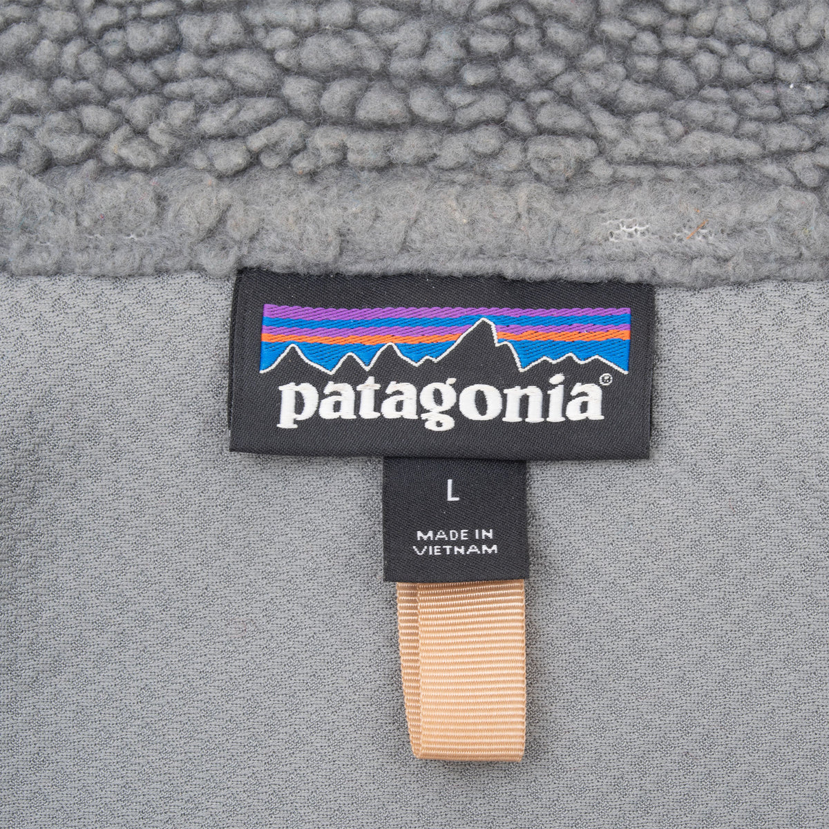 Patagonia neck label and large size tag inside grey fleece vest