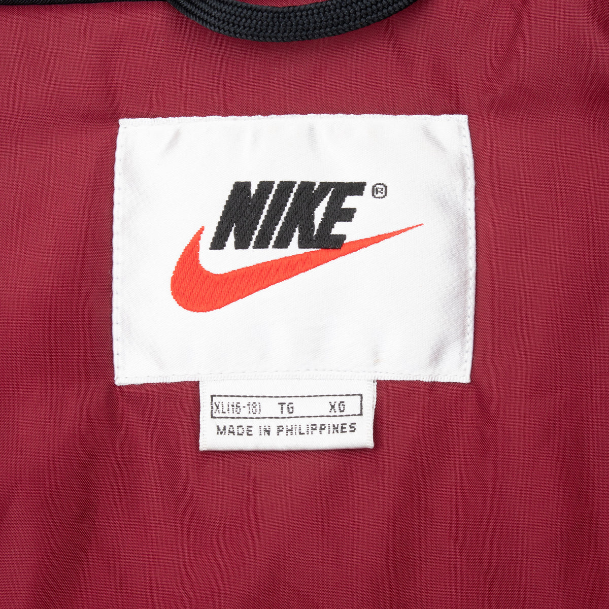 Nike neck label and XL size tag inside burgundy windbreaker jacket