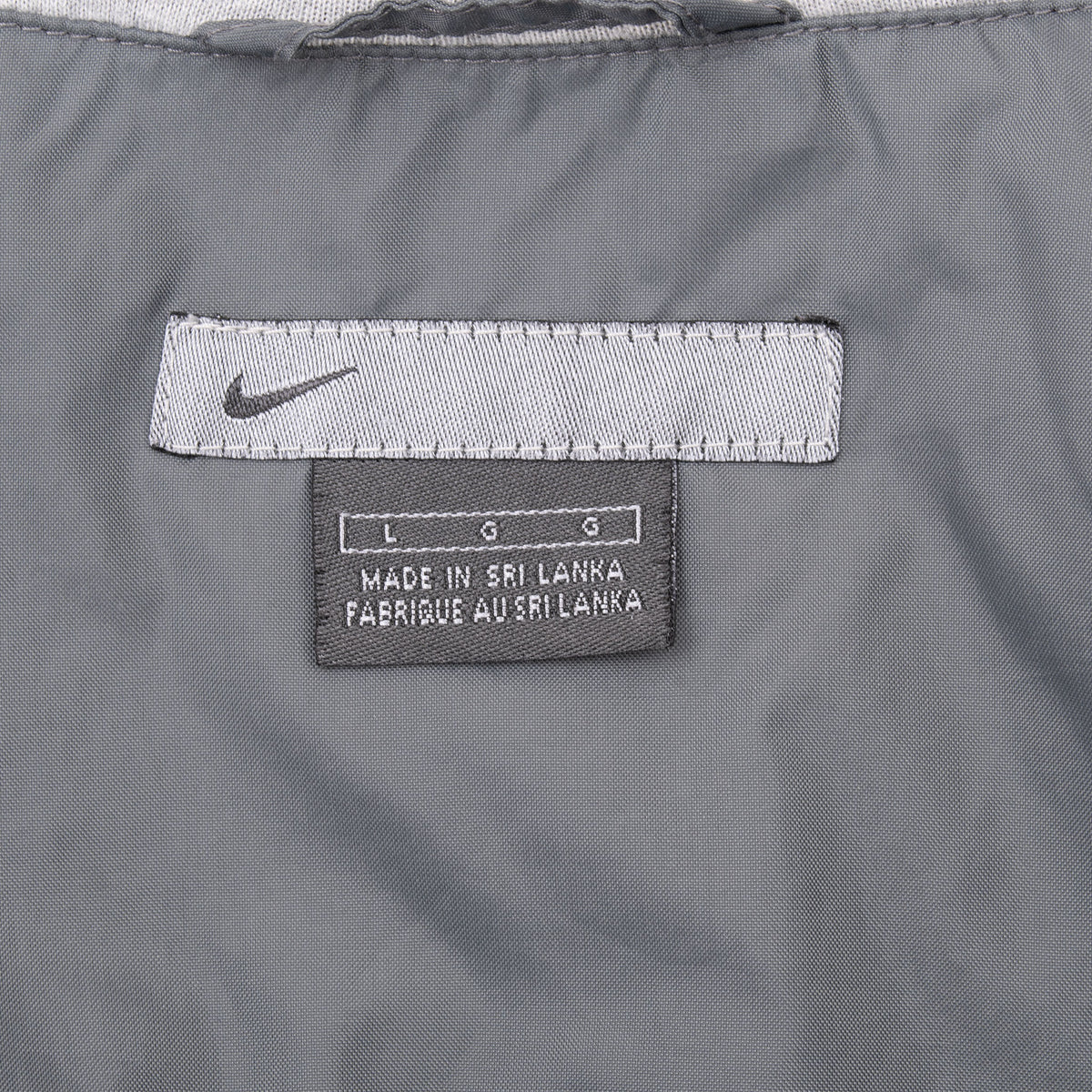 Nike interior neck and size L labels on grey hooded windbreaker