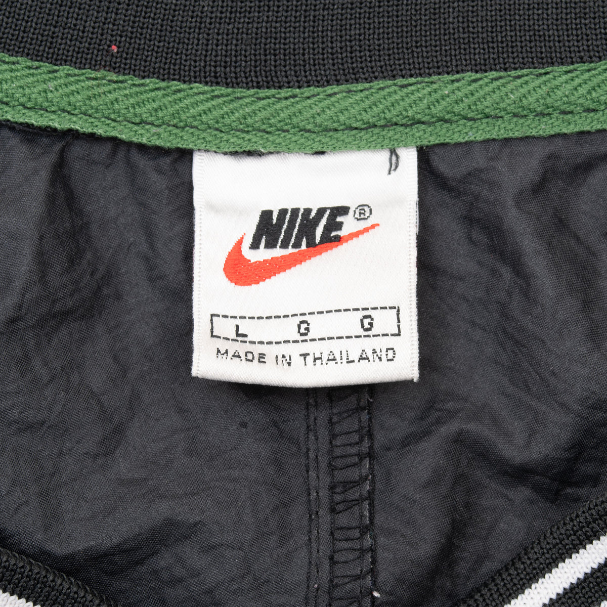 Nike neck label showing size large inside black pullover windbreaker