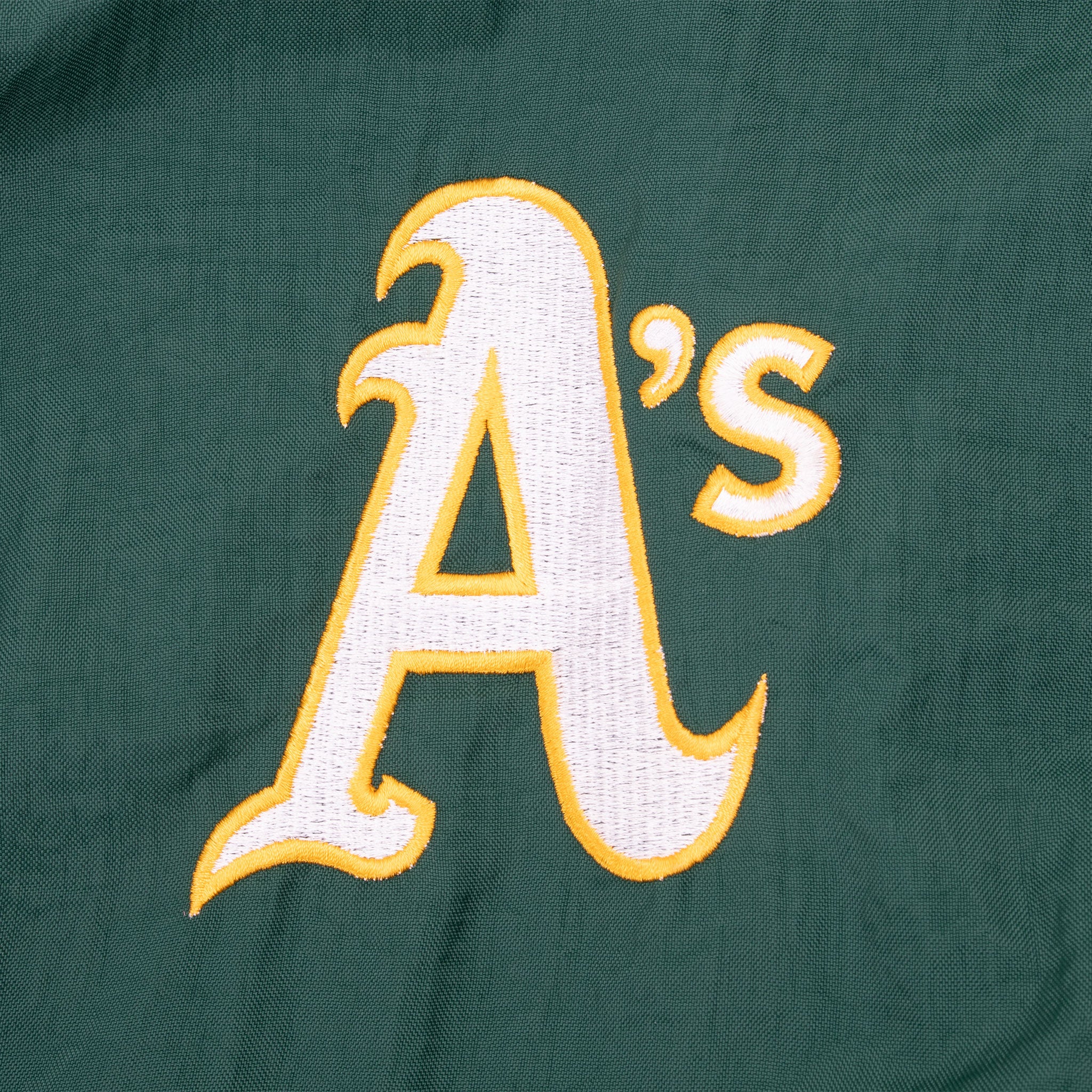 White and yellow Oakland A's logo embroidery on green jacket chest