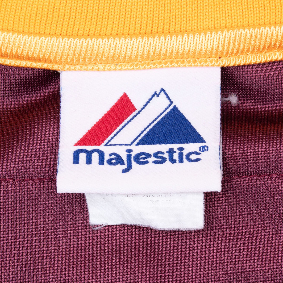 Majestic brand neck tag inside the maroon and gold jersey collar