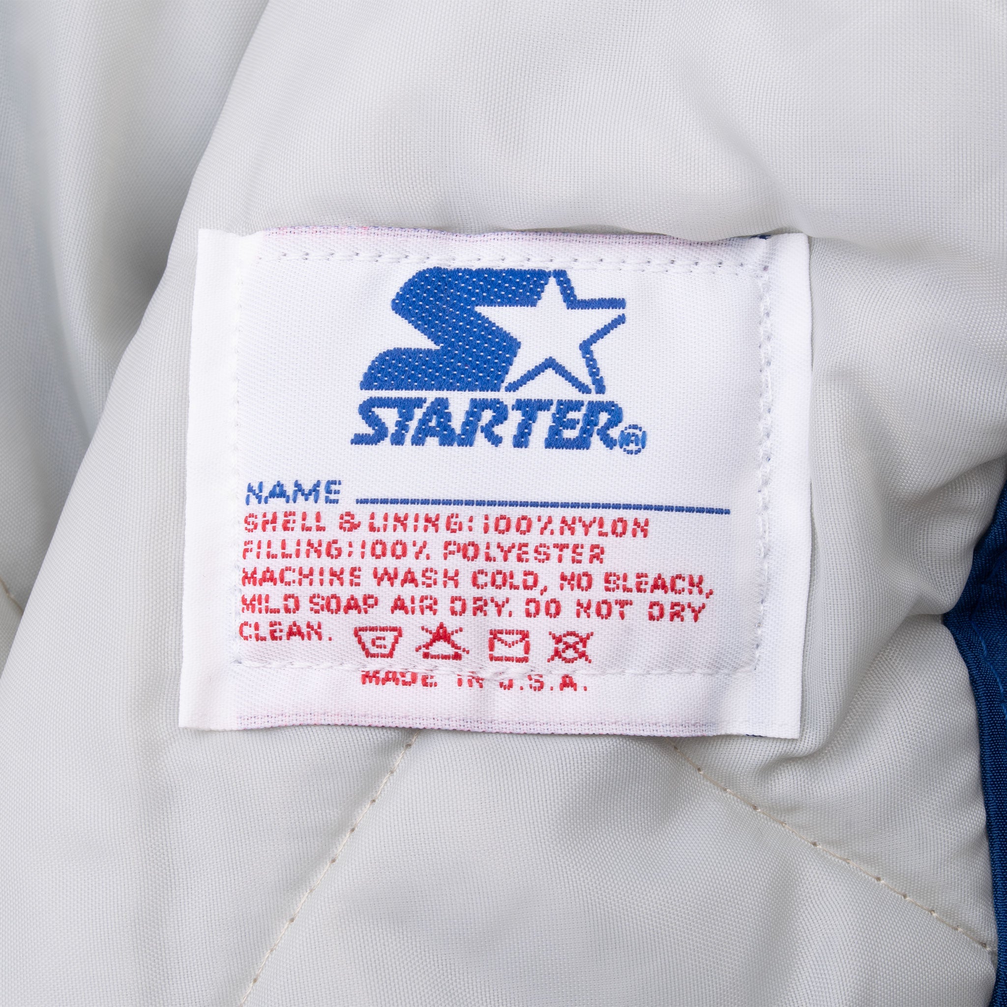 Starter care label listing nylon shell, polyester filling, and Made in USA