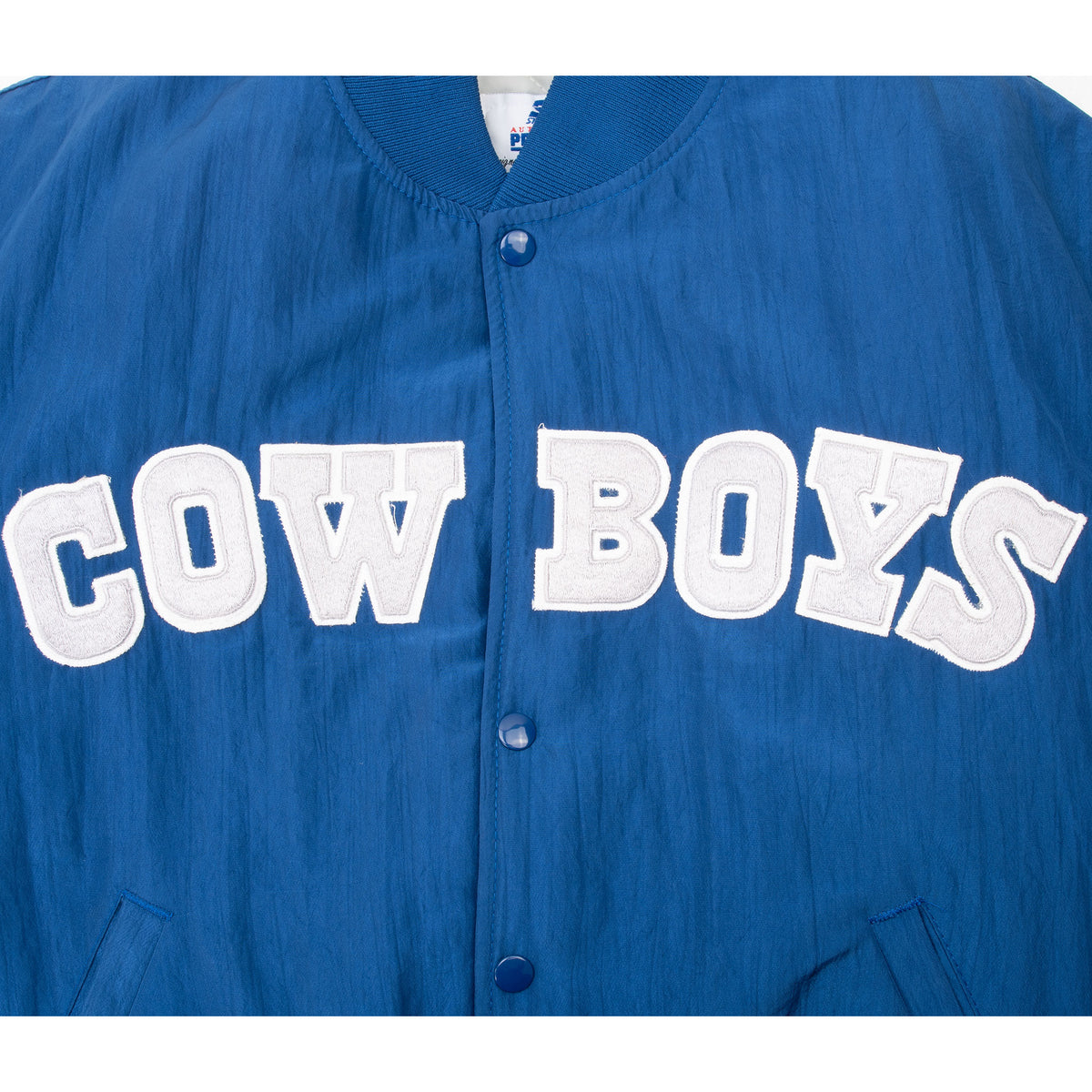 Close-up of white Cowboys lettering on blue snap-front jacket