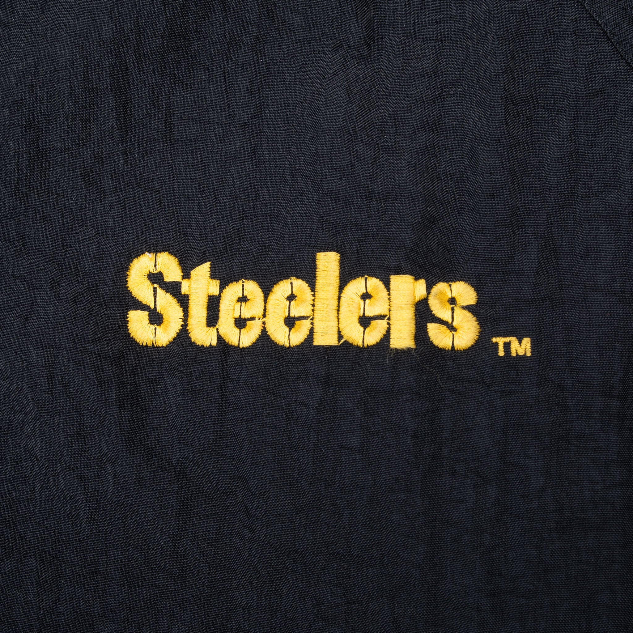 Gold Steelers chest embroidery on black jacket fabric