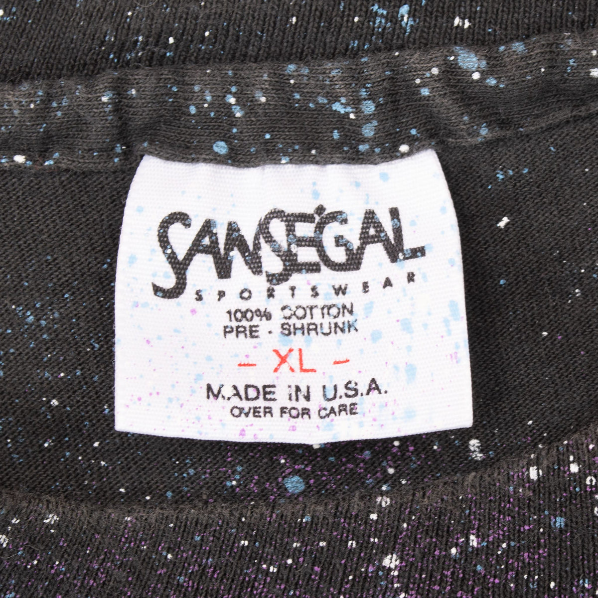 Close-up of Canyon Sportswear neck label marked 100% cotton, XL and made in USA