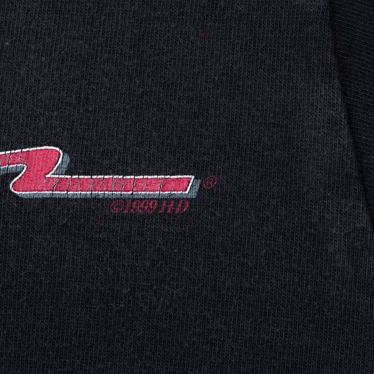 Close-up of 1999 H-D copyright mark beside the chest print