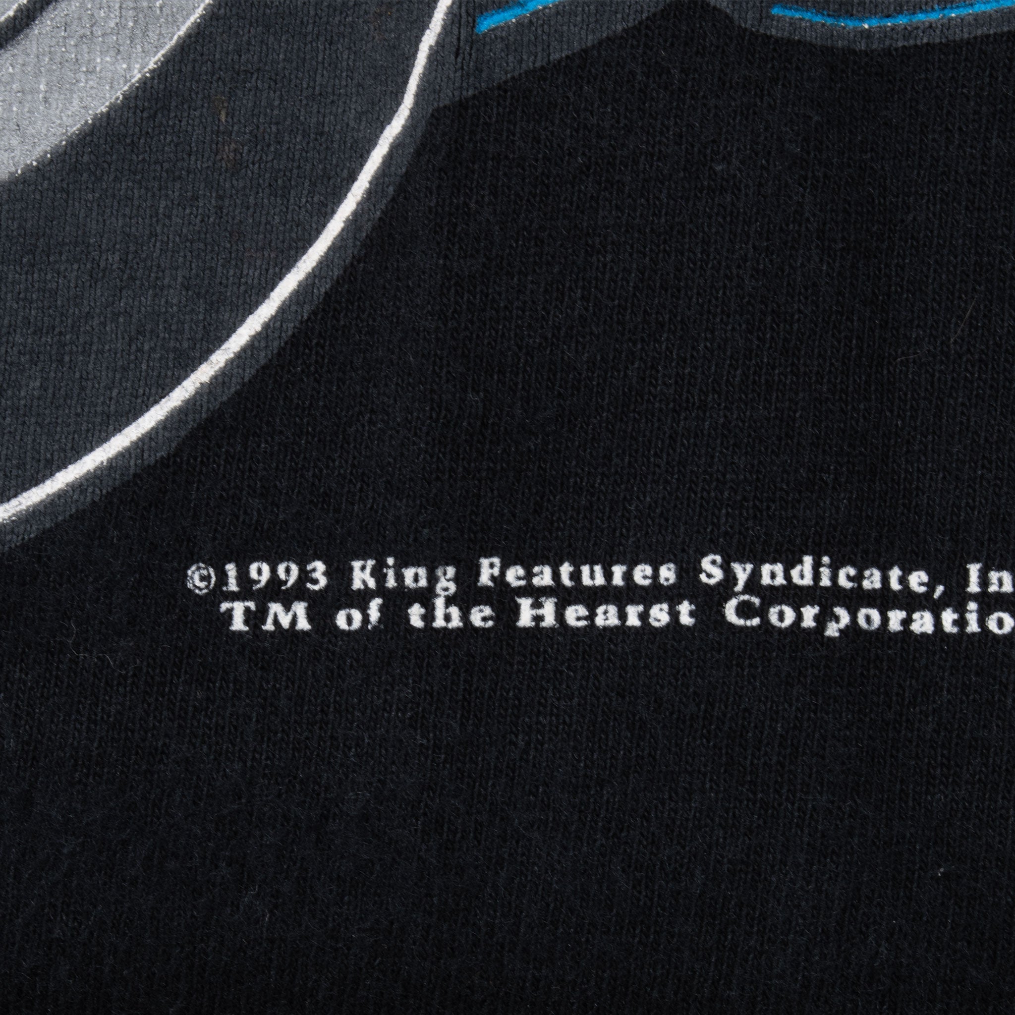 Close-up of 1993 King Features Syndicate copyright print on black fabric