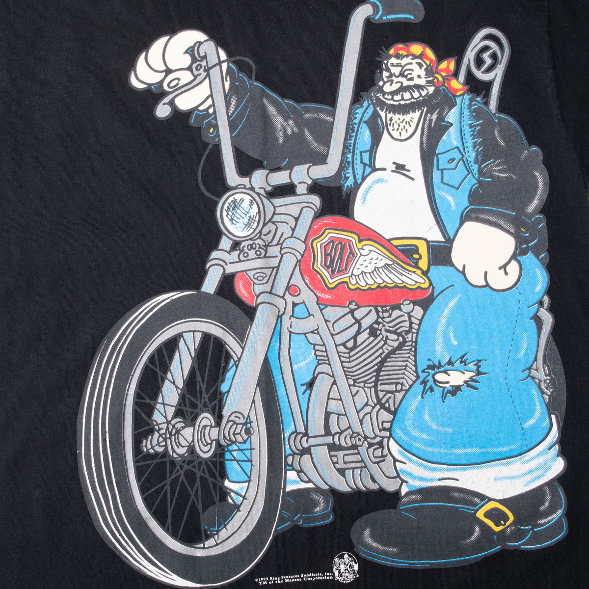 Close-up of front print showing Brutus from Popeye with a red and blue motorcycle