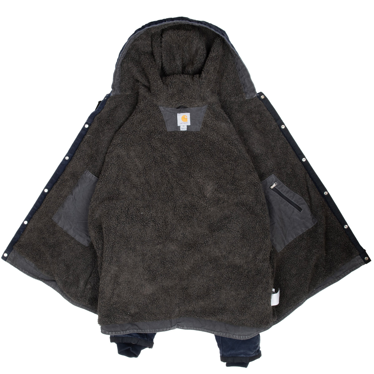 Open Carhartt jacket showing dark sherpa lining, lined hood, and interior pockets