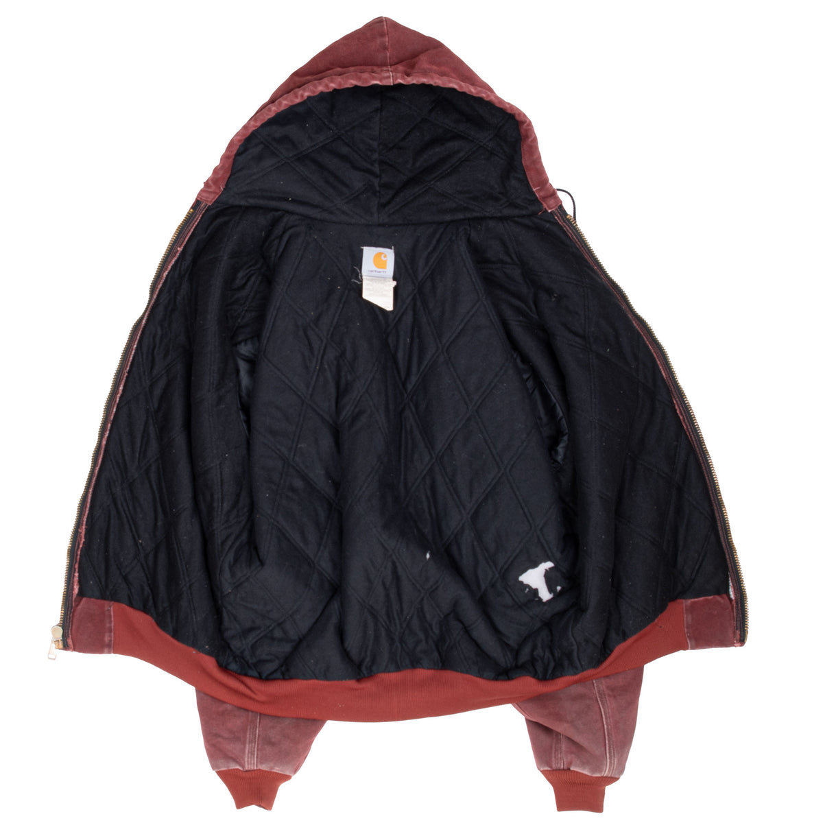 Open Carhartt jacket showing black quilted lining and interior label