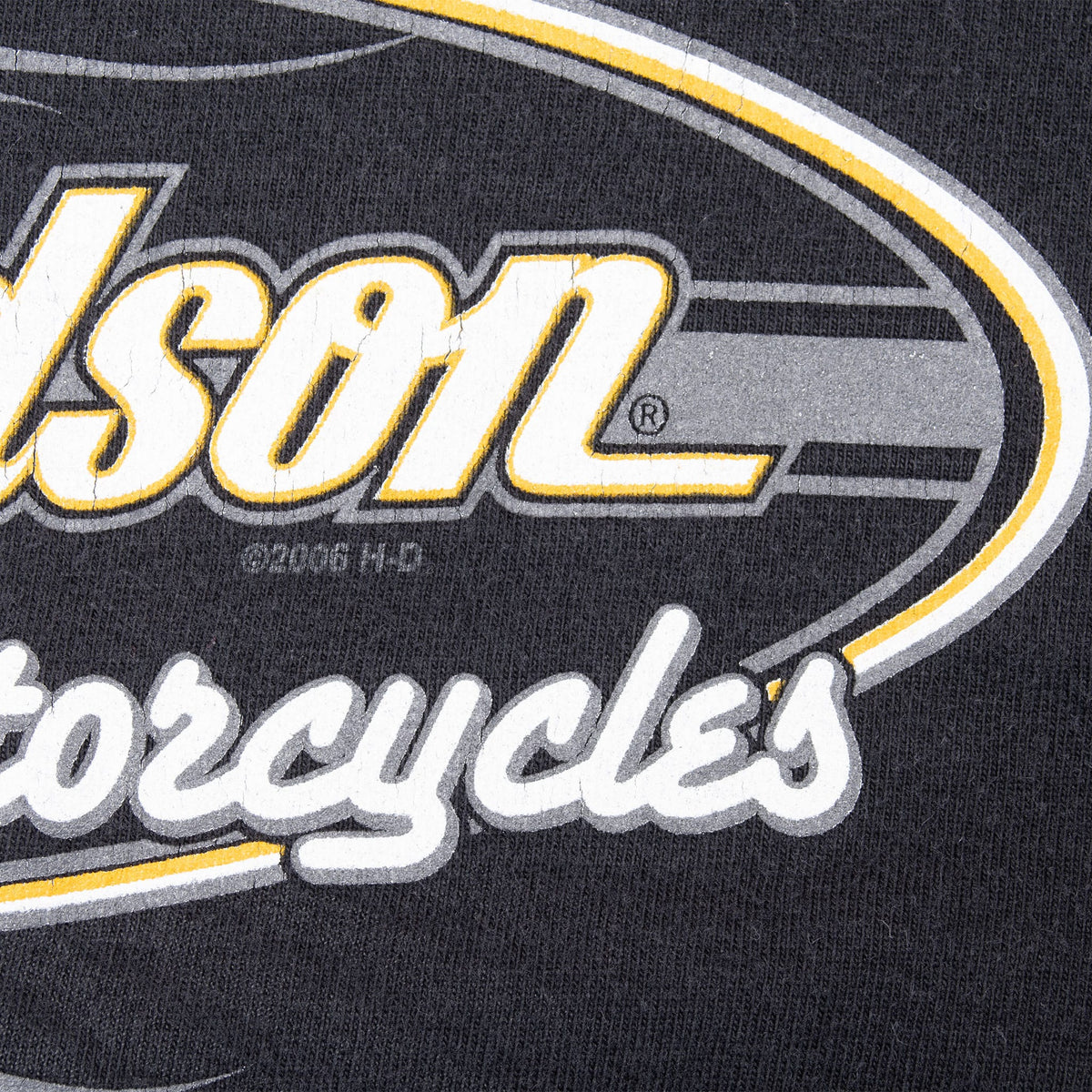 Close-up of white, yellow and gray Harley-Davidson front print on black fabric