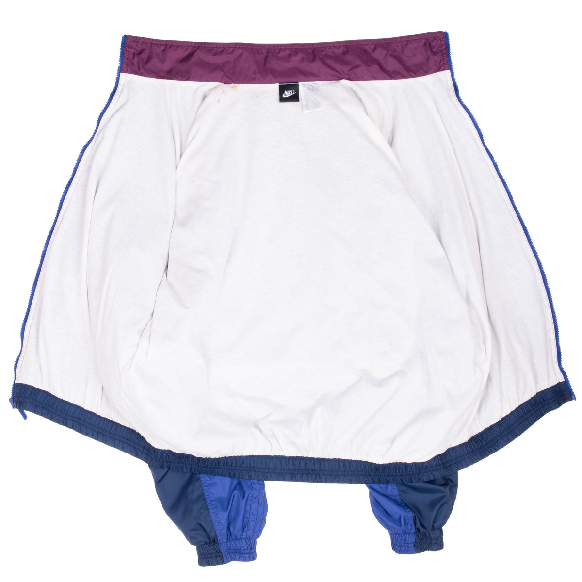 Open Nike windbreaker showing white interior lining and purple collar