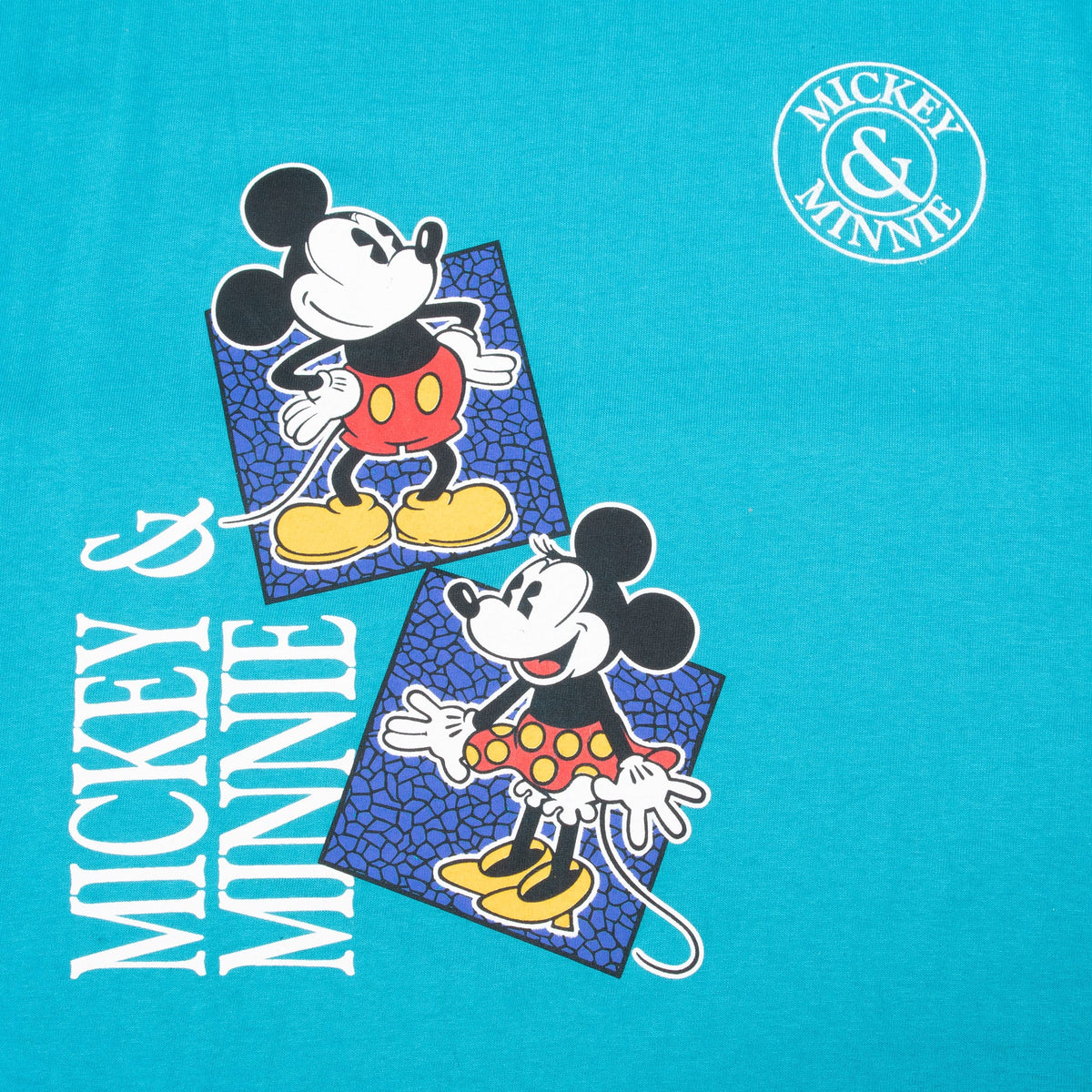 Close-up of Mickey and Minnie front graphic, vertical lettering, and circular chest emblem